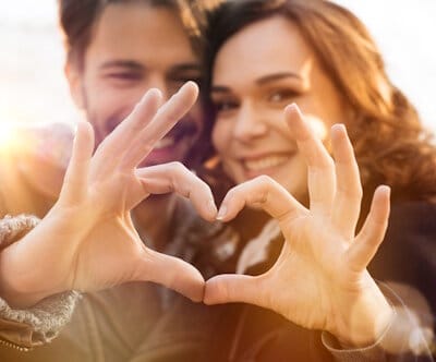 Closeup,of,couple,making,heart,shape,with,hands